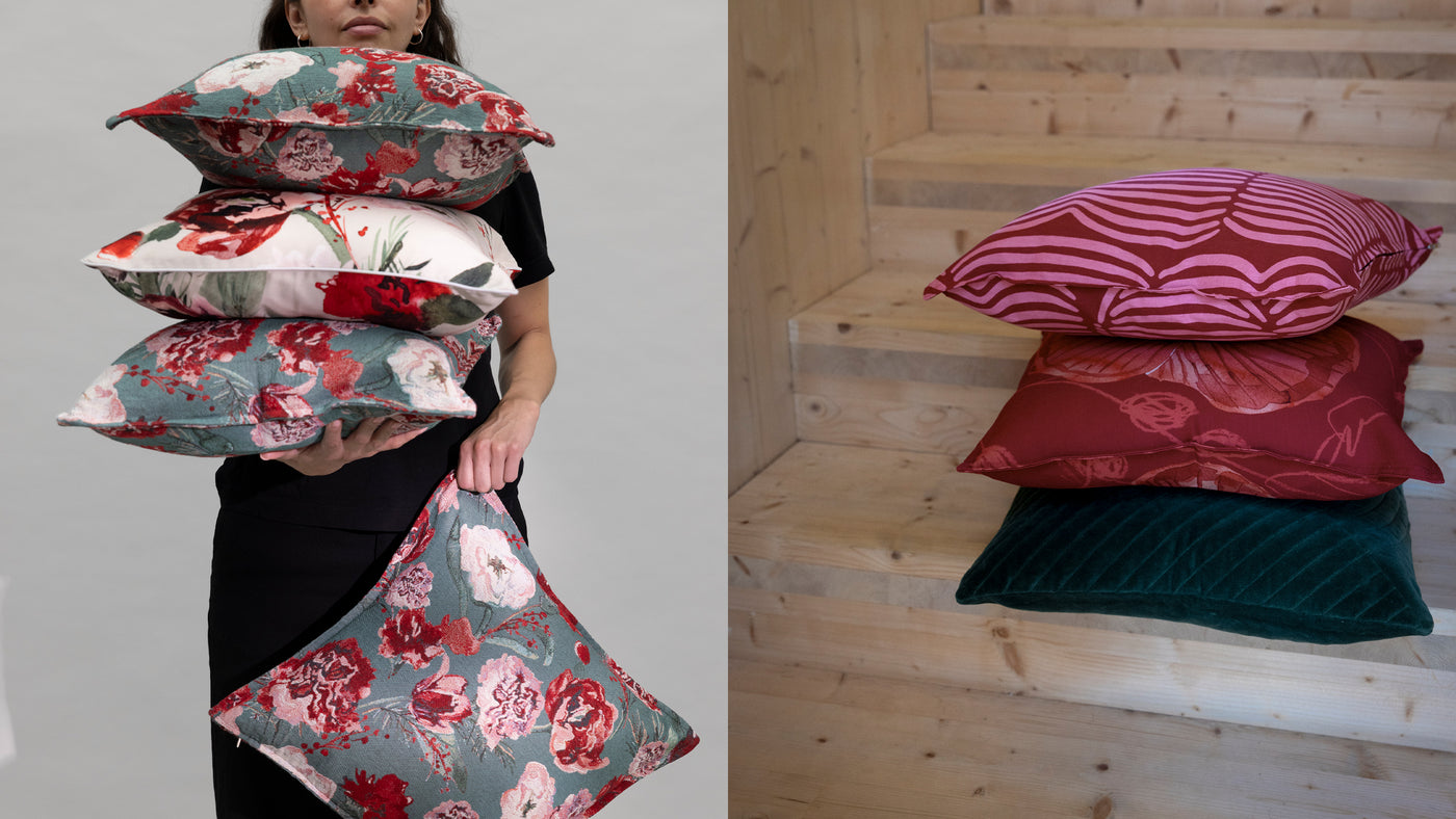 Two images: Person holding floral-patterned pillows and a pile of decorative pillows in staircase. Redirects to cushion covers product collection.